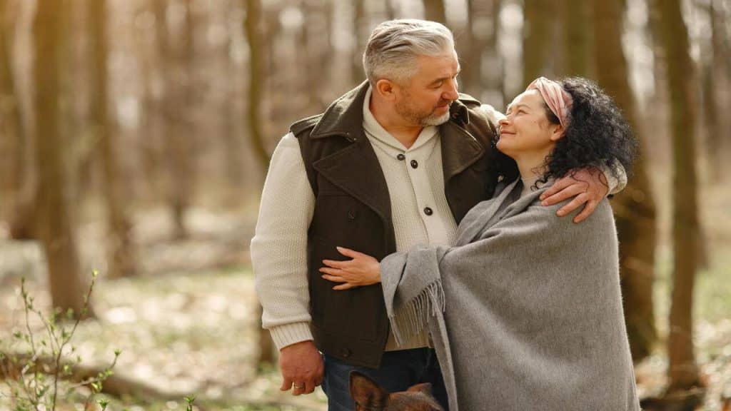 A couple hugging in the woods