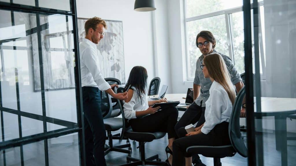 A group of people having a meeting in a modern office.
