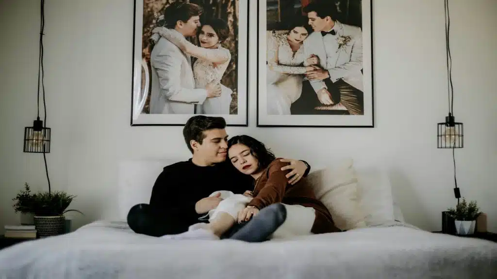 A couple cuddling in bed.