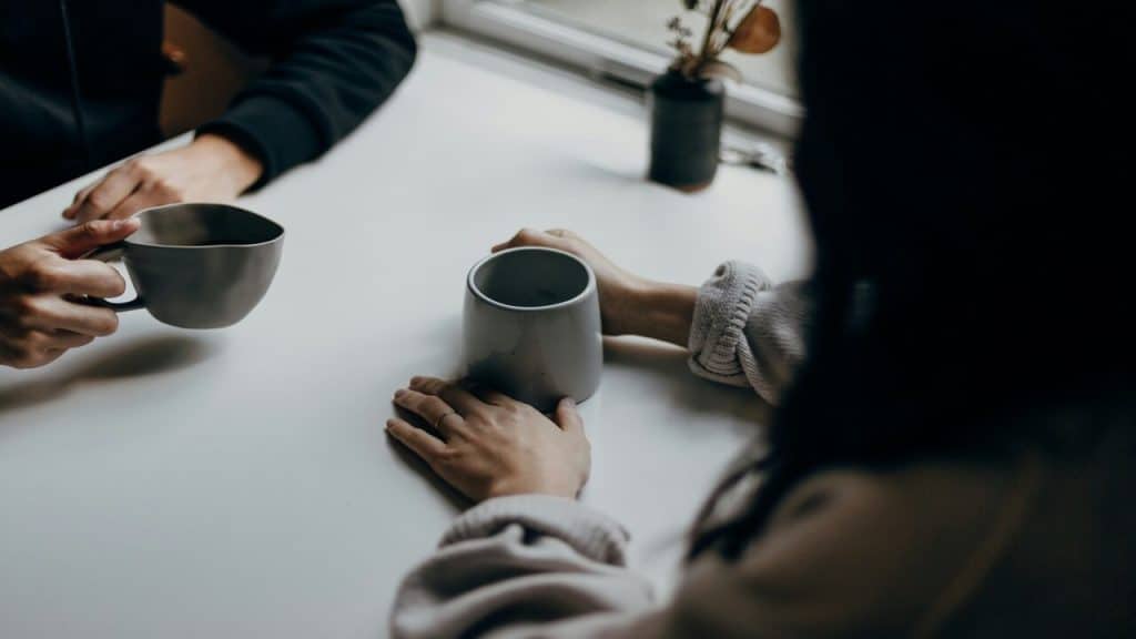 A couple talking over coffee