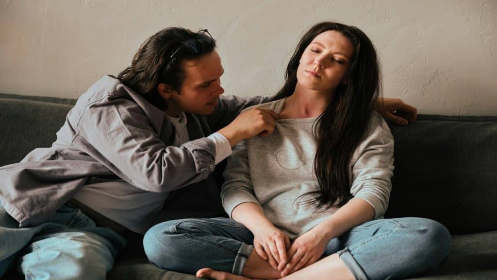 A woman avoiding her husband’s kiss