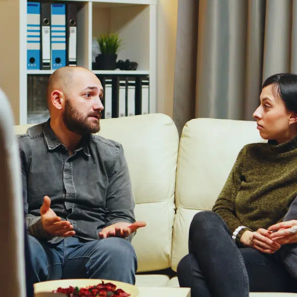Couple having serious conversation on a couch