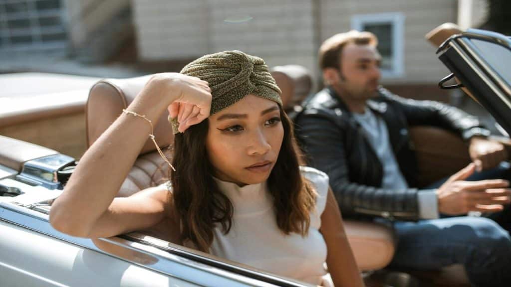 A couple ignoring each other in the car