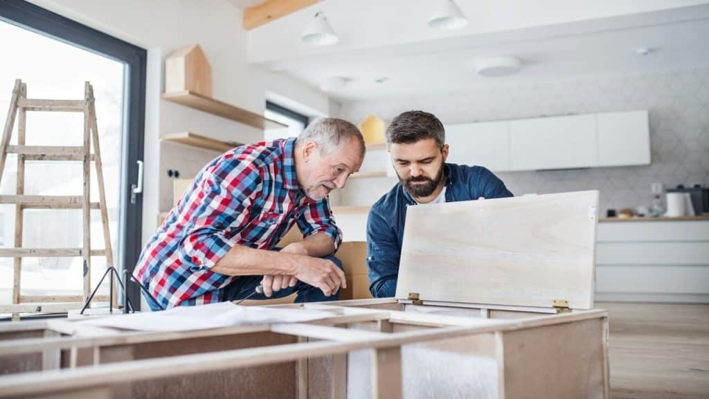 A father and son assembling furniture