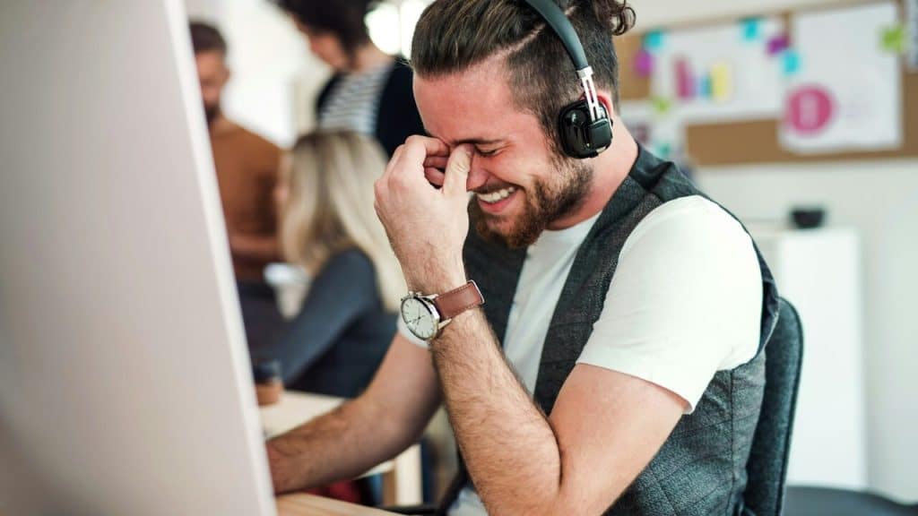 A man laughing in the office