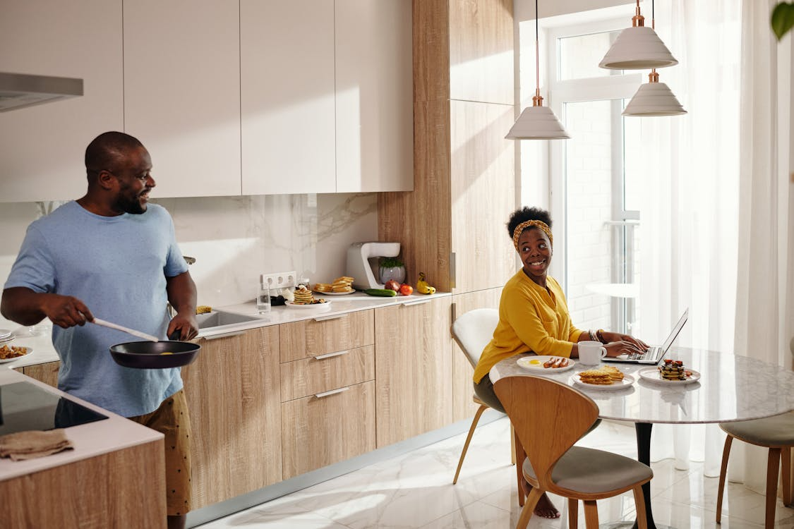 Man and woman having pleasant conversation in kitchen