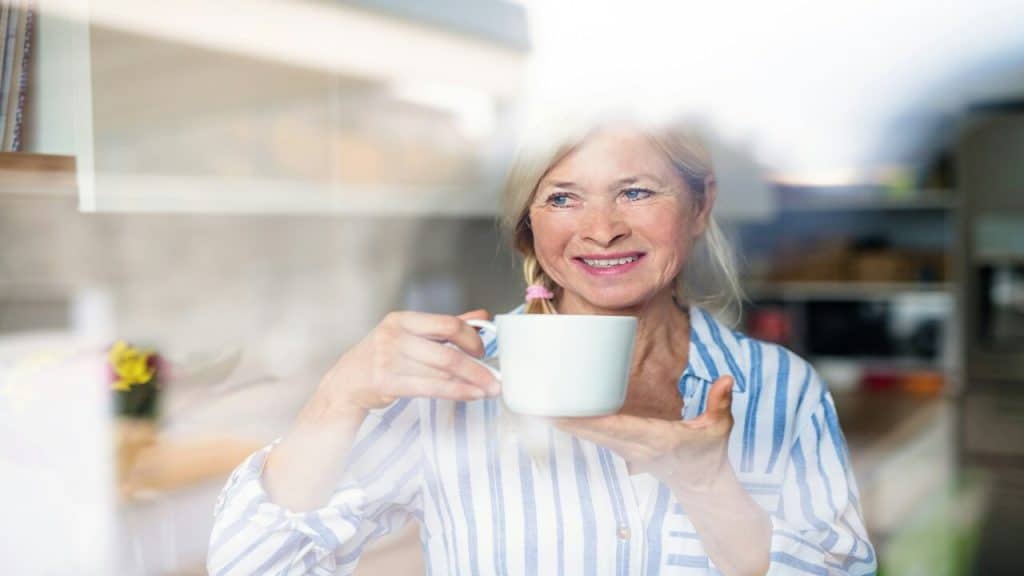 A beautiful mature woman enjoying coffee at home 