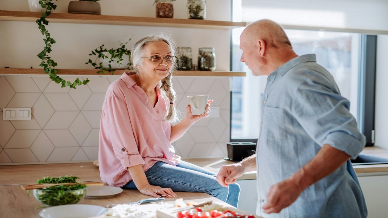A couple talking in the kitchen