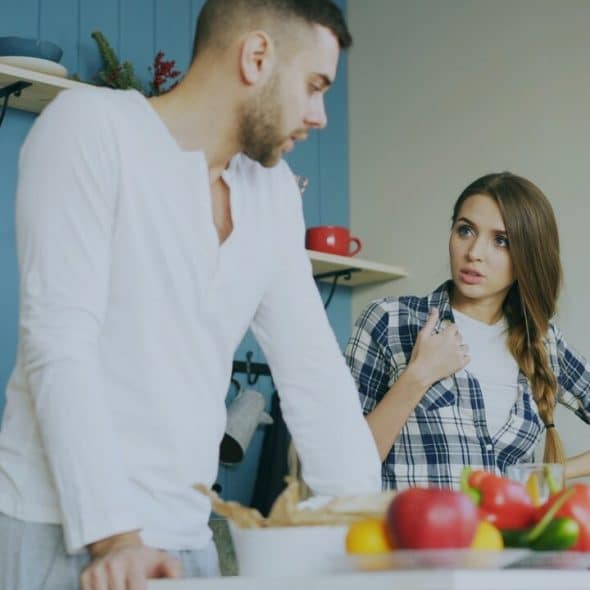 A couple talking in the kitchen