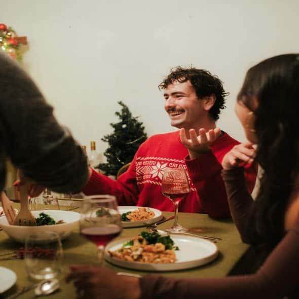 A man entertaining his friends during a meal