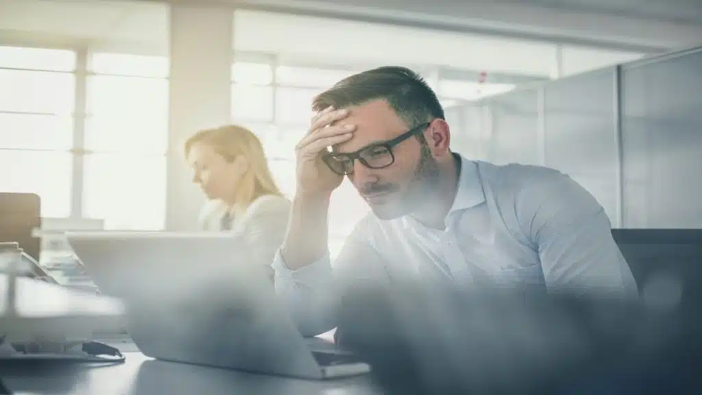 A man looking stressed at home
