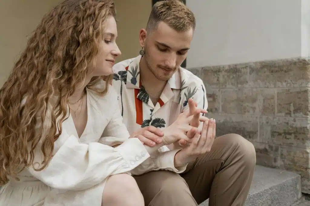 A man holding woman’s hand