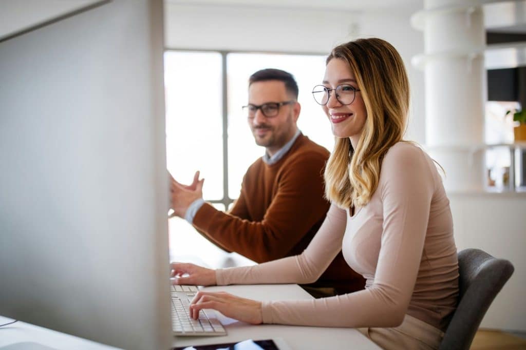 A woman busy working and a man beside her