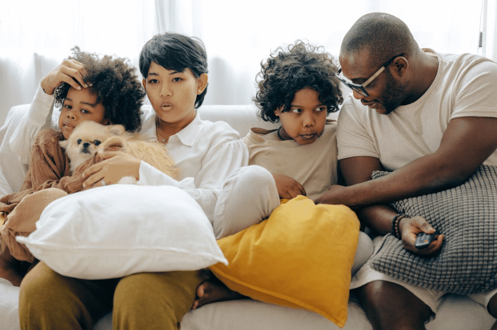 A family sitting on a couch