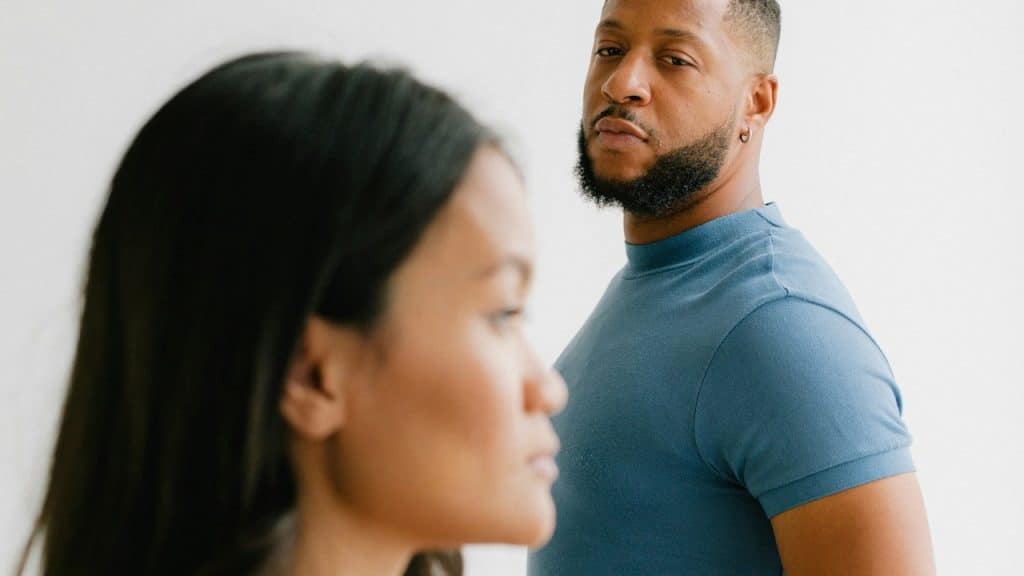 A bearded man looking at a woman.