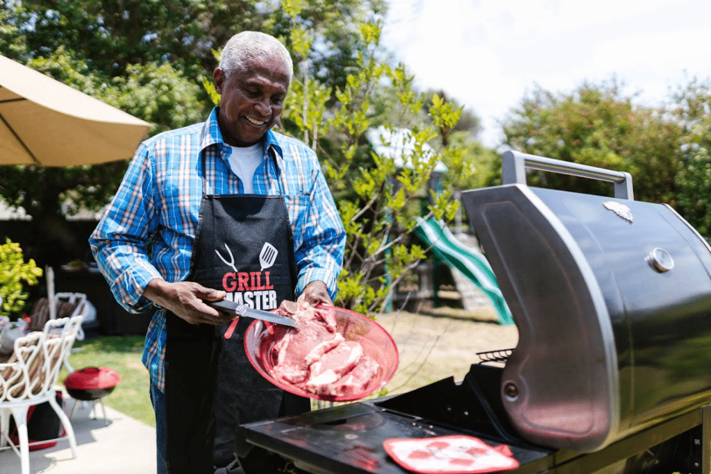 Man happily grilling meat