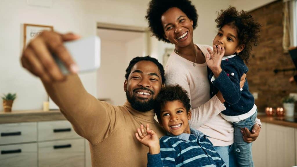 A family taking a selfie together at home.