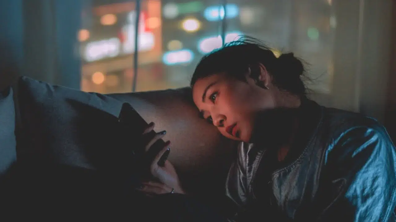 A woman looking sad while texting
