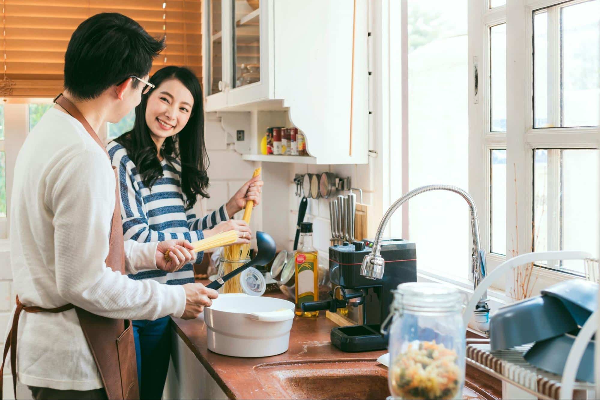 A man and woman in the kitchen 
