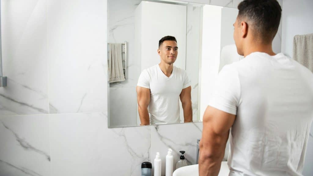 A man looking at the mirror.