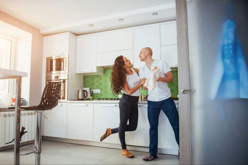 A man and woman at the kitchen