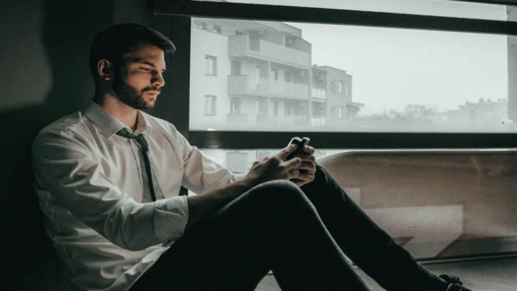 A man looking sad while texting