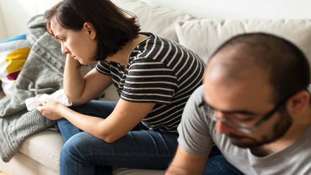 A couple arguing on the sofa 
