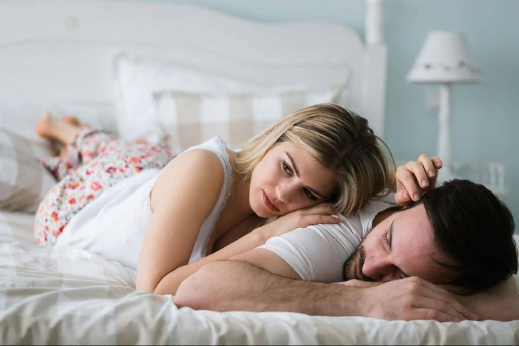 A woman lying on man’s back