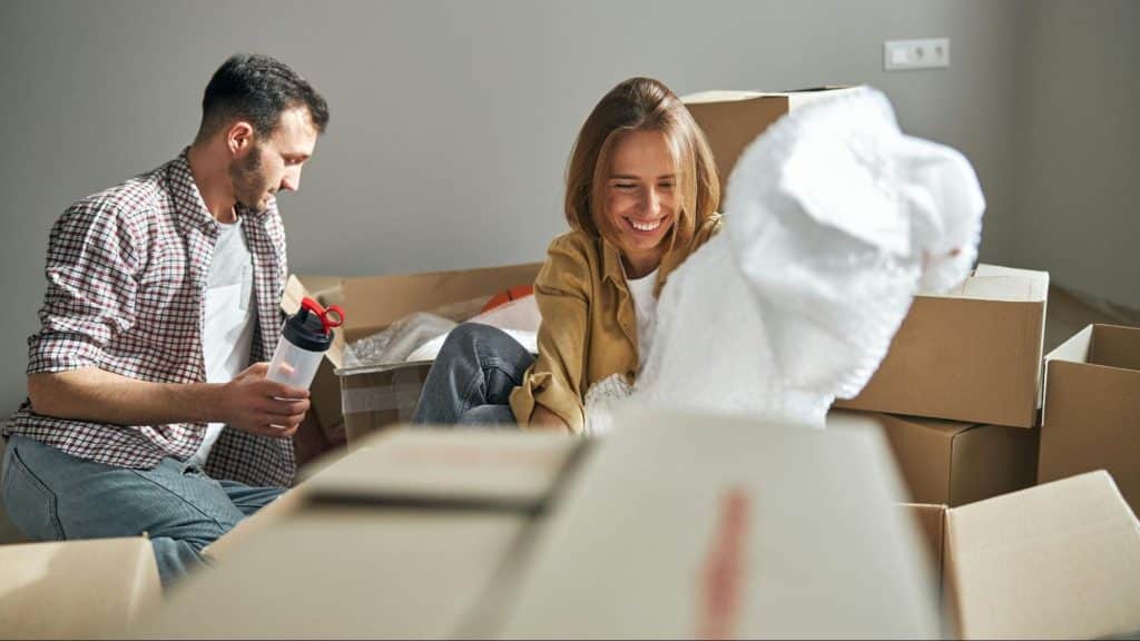 A man and woman unpacking