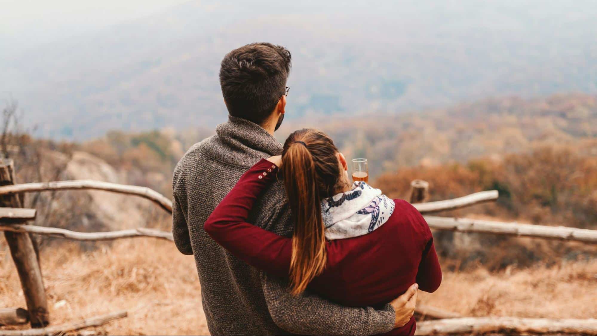 A man and woman looking at the view