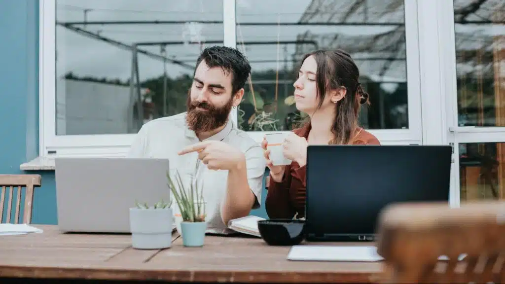 A man and woman having their own laptop