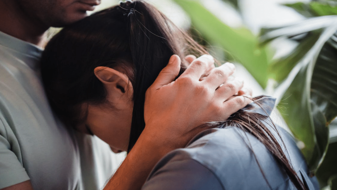 A couple hugging at home