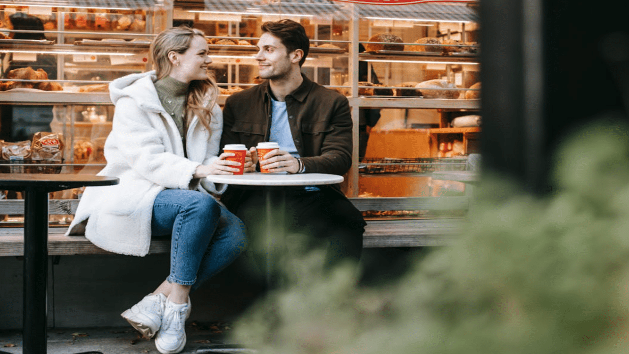 A couple talking at a cafe