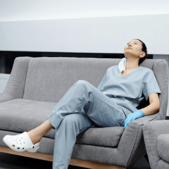 A tired nurse reclining on the couch