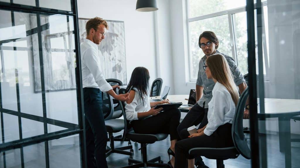 A group of people having a meeting in a modern office.