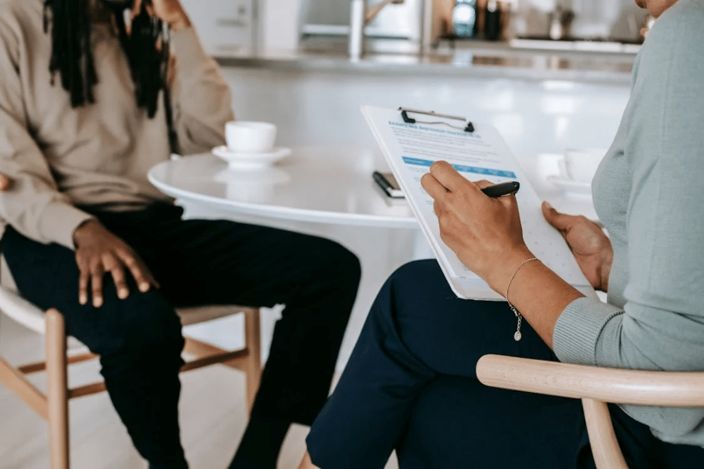 Crop couple sitting at table going through interview