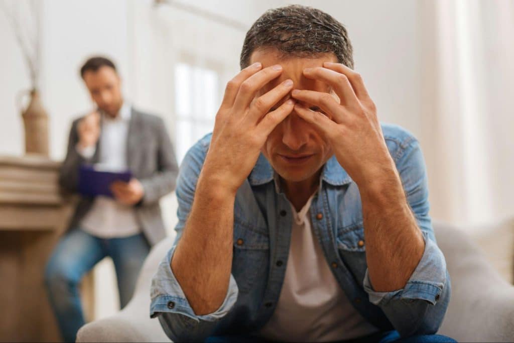 A man holding his head