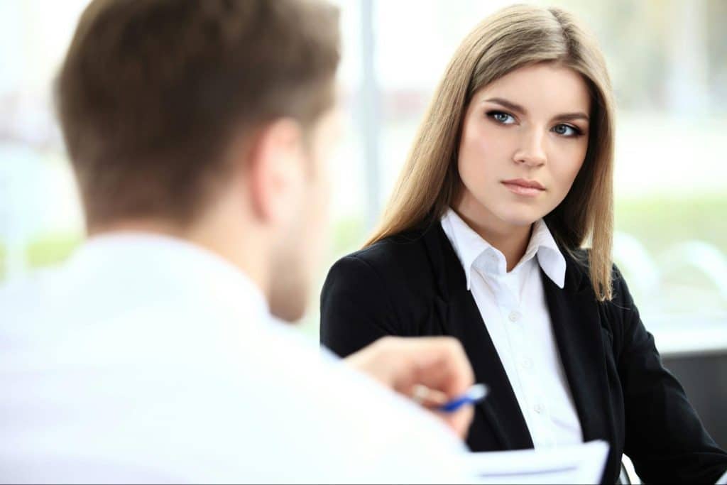 A woman looking at the man