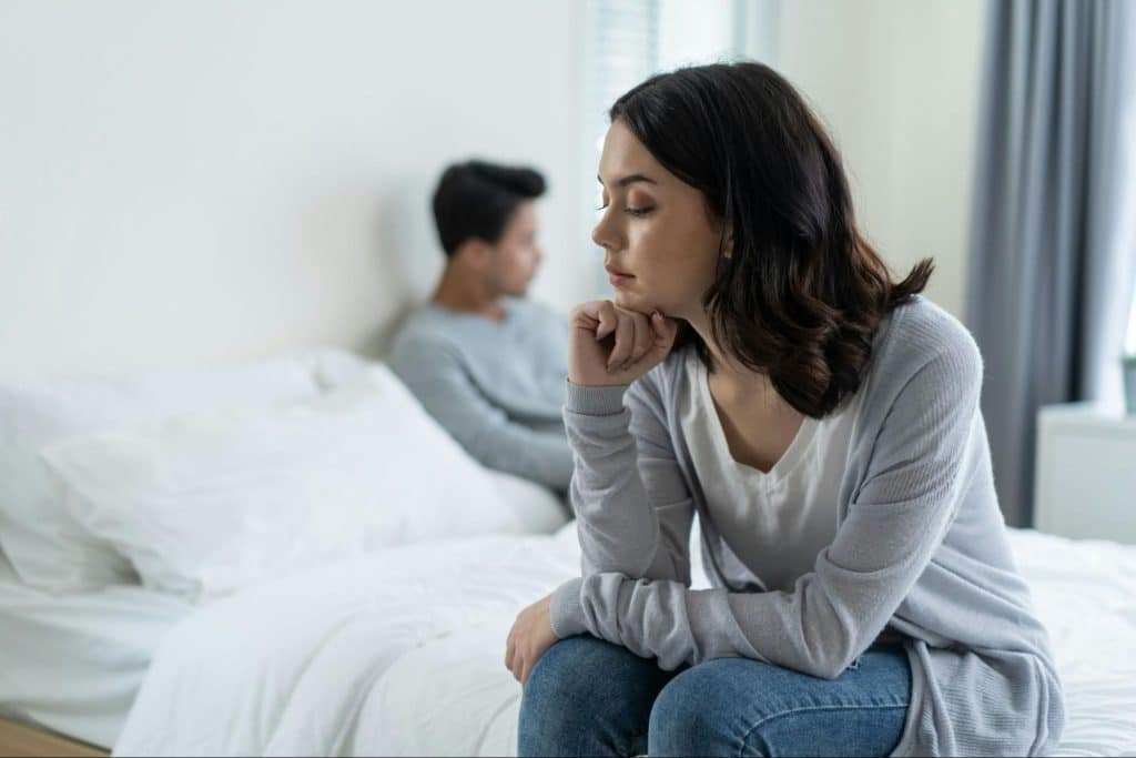 A man sulking and a woman thinking about it 
