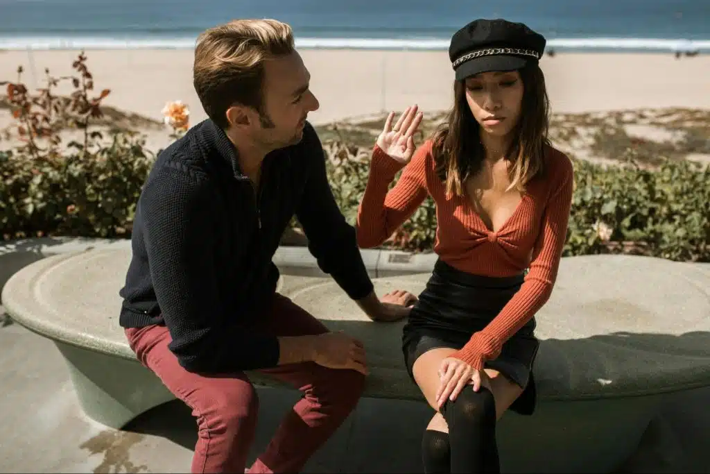 A man playing a guitar for a woman