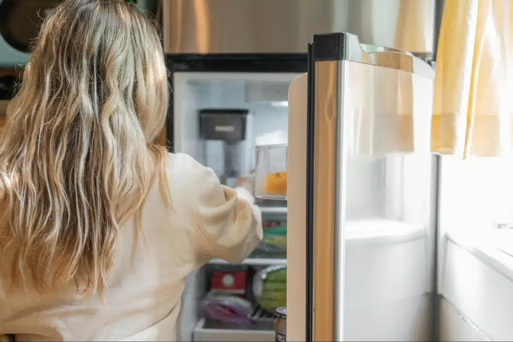 A woman checking their refrigerator
