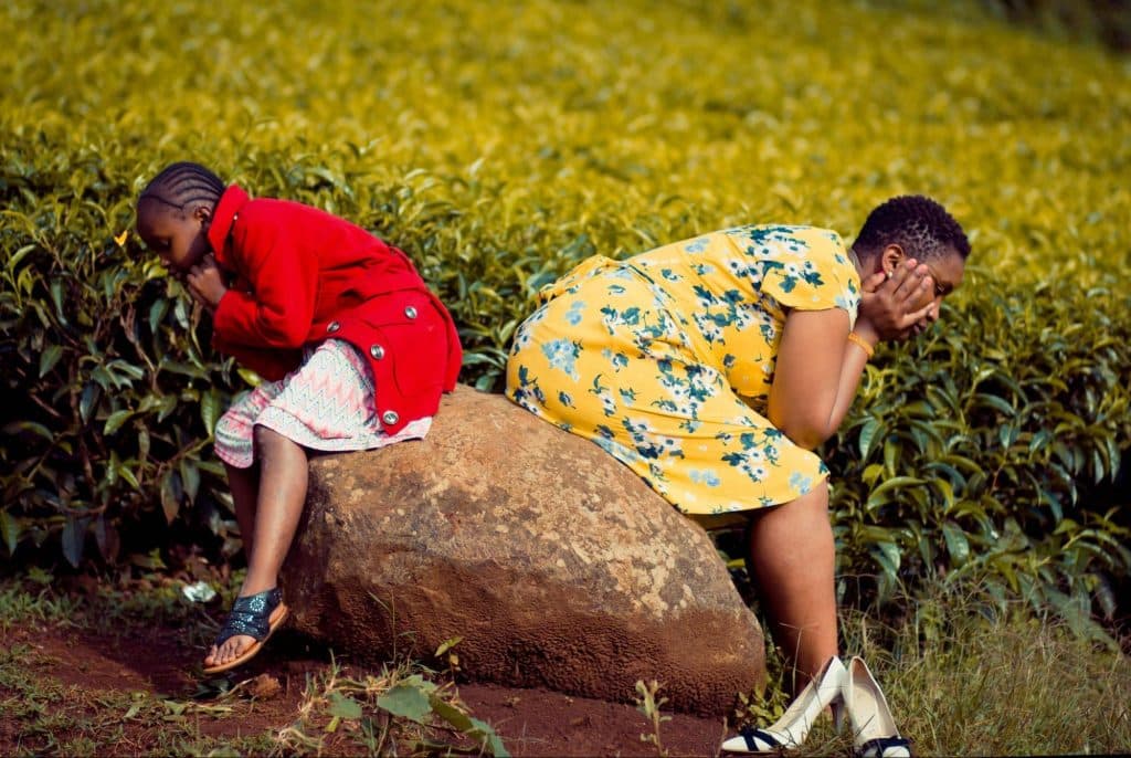 A sad woman and  not comforted with her kid 