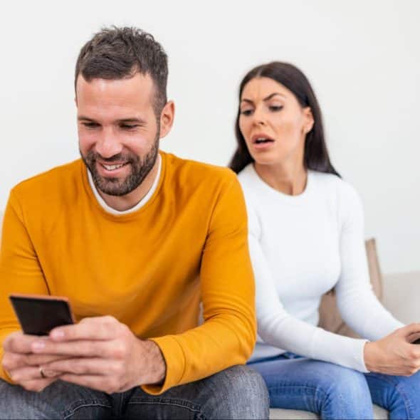 A woman looking at the man’s activity