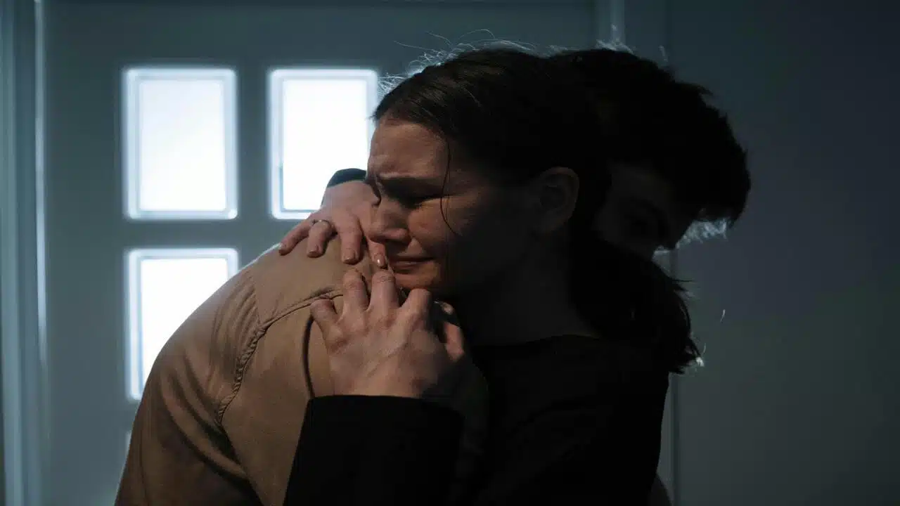 A couple hugging while crying
