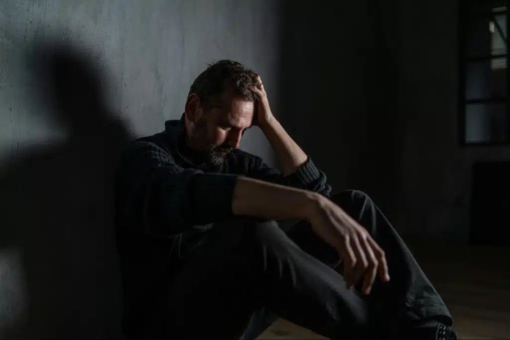 A sad man alone in the dark