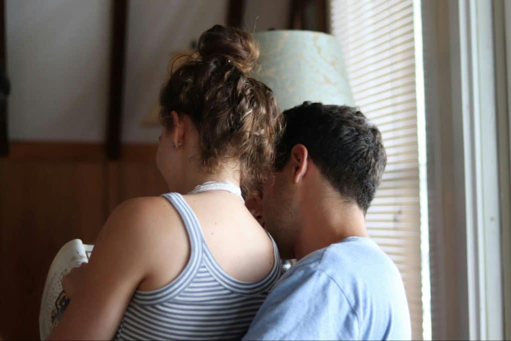 A woman sitting on the lap of a man