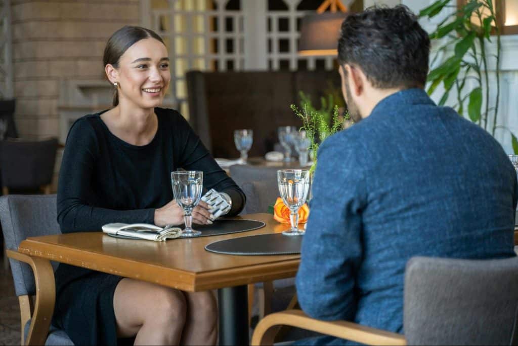 A woman smiling at the man