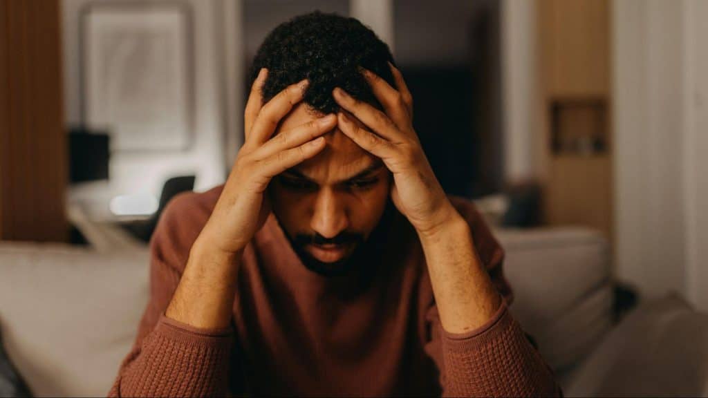 A man holding his head