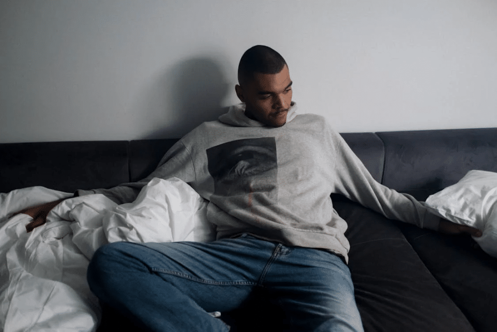A man on a sofa with blankets