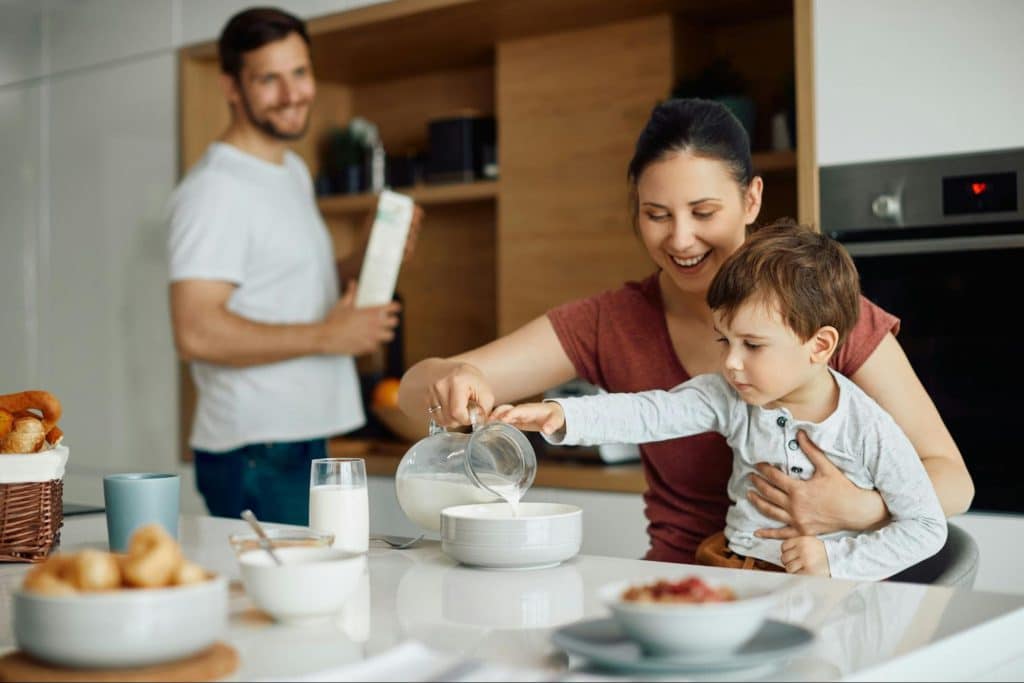 A man looking happily with his wife and son